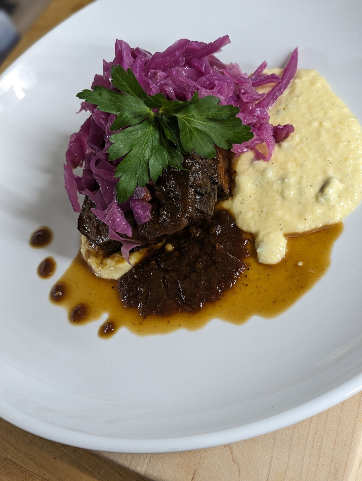 "Tantalizing Trio: Cola-Braised Ribs, Jalapeño Cheddar Grits & Roasted Cabbage"